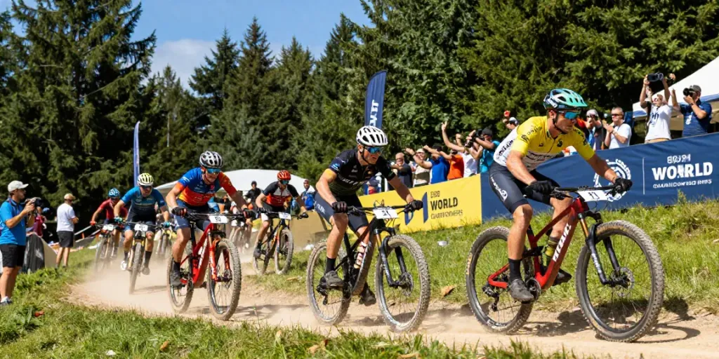 Action-packed MTB racing at the 2026 World Championships, with cyclists showcasing skills and energy amidst the excitement, highlighting notizie ciclismo.